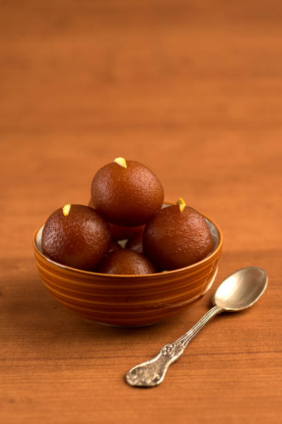 Catering Packages gulab jamun in bowl on wooden background. indian dessert or sweet dish.